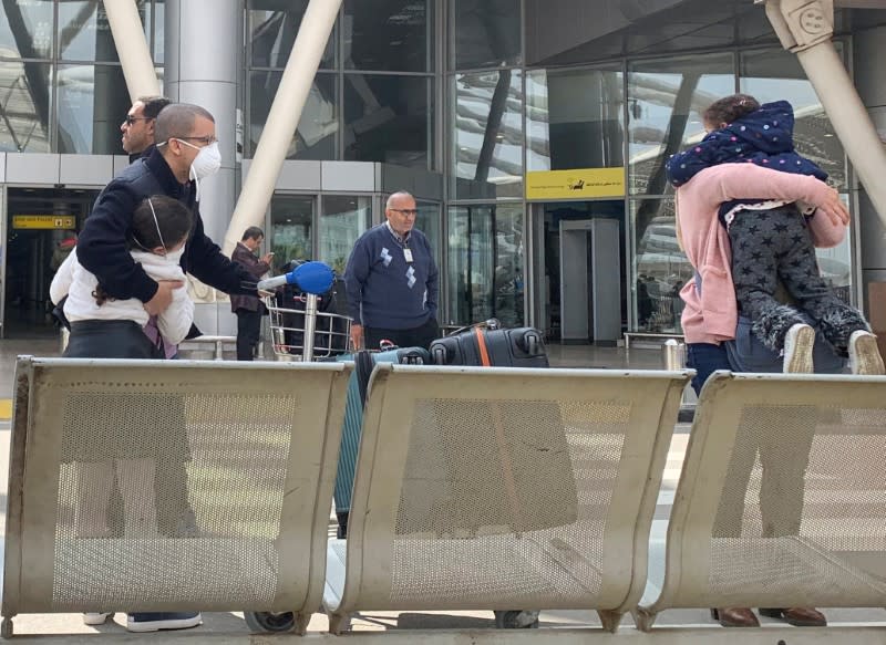 Parents wearing protective face mask hug their children upon their arrival, at Cairo International Airport (CAI) as Egypt ramps up its efforts to slow the spread the coronavirus disease (COVID-19) in Cairo