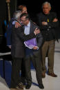 President-elect Gustavo Petro and Francisco de Roux, president of a truth commission, embrace during a ceremony to release a final report by the government-appointed commission regarding Colombia's internal conflict, in Bogota, Colombia, Tuesday, June 28, 2022. A product of the 2016 peace deal between the government and the Revolutionary Armed Forces of Colombia, FARC, the commission was tasked to investigate human rights violations committed by all actors between 1958 and 2016. (AP Photo/Ivan Valencia)