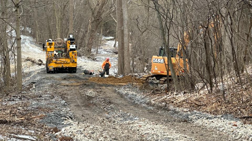 Crews work to repair a water main break near the area of Leonard Street NE and Union Avenue NE near Carrier Creek in Grand Rapids.