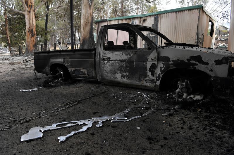 A burnt out vehicle is seen at a destroyed property in Sarsfield in East Gippsland