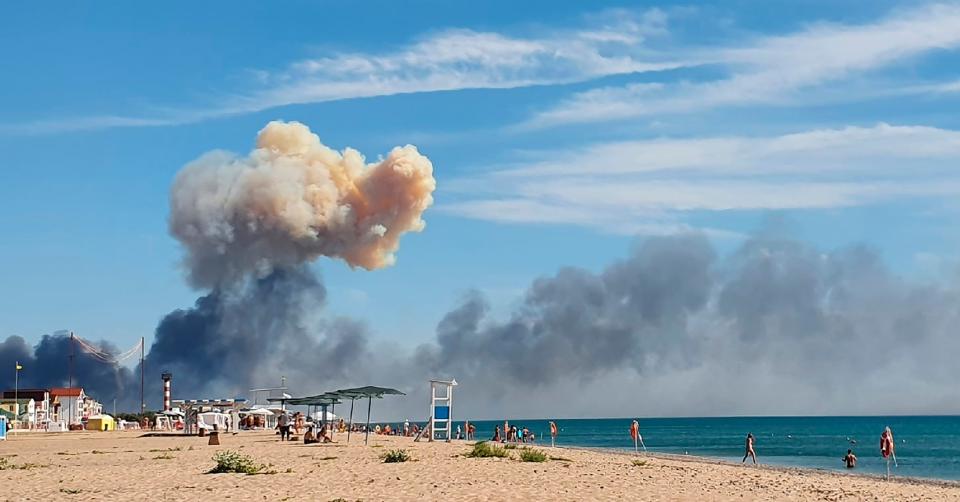 Rising smoke can be seen from the beach at Saki after explosions were heard from the direction of a Russian military air base near Novofedorivka, Crimea, Aug. 9, 2022. More massive explosions and fires hit a military depot in Russia-annexed Crimea on Aug. 16, 2022.