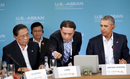 A microphone is adjusted for remarks by U.S. President Barack Obama and Laos President Choummaly Sayasone (L) at the 10-nation Association of Southeast Asian Nations (ASEAN) summit at Sunnylands in Rancho Mirage, California February 15, 2016. REUTERS/Kevin Lamarque