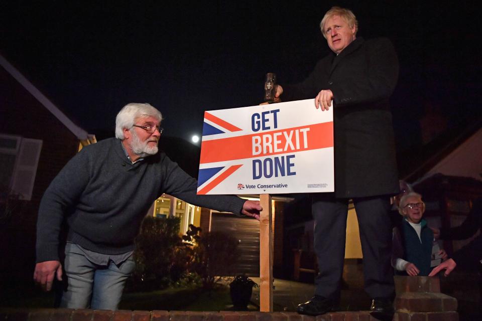 Britain's Prime Minister and Conservative party leader Boris Johnson poses as he hammers a 