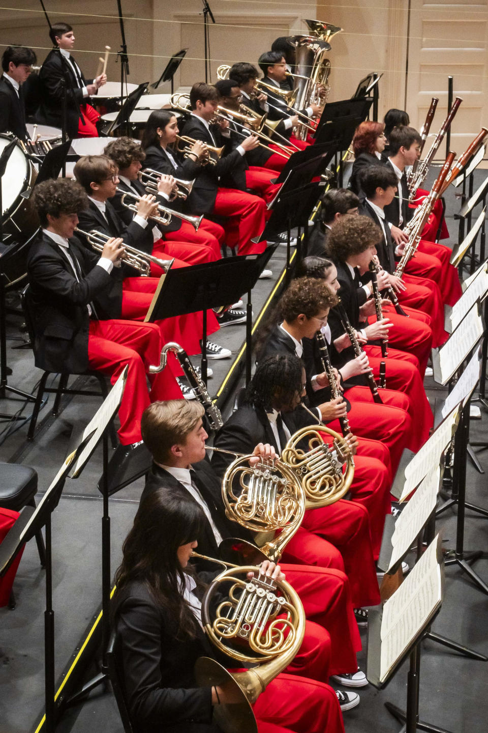 This image provided by the Carnegie Hall shows the National Youth Orchestra of the USA. Teenaged musicians from the National Youth Orchestra of the USA walked onto the Carnegie Hall stage before rehearsal and had a uniform reaction, much like string sections following their leaders: They pulled out cell phones and took selfies. Carnegie Hall's initiative to train the next generation turned 10 this year. (Chris Lee/Carnegie Hall via AP)