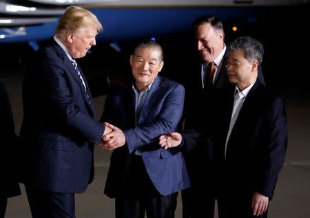 U.S.President Donald Trump greets the Americans formerly held hostage in North Korea upon their arrival at Joint Base Andrews, Maryland, U.S., May 10, 2018. REUTERS/Joshua Roberts