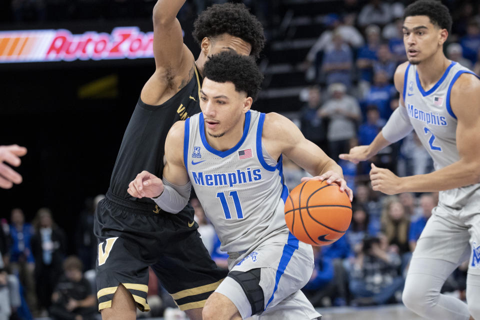 Vanderbilt guard Paul Lewis, left, defends Memphis guard Jahvon Quinerly (11) during the first half of an NCAA college basketball game Saturday, Dec. 23, 2023, in Memphis, Tenn. (AP Photo/Nikki Boertman)