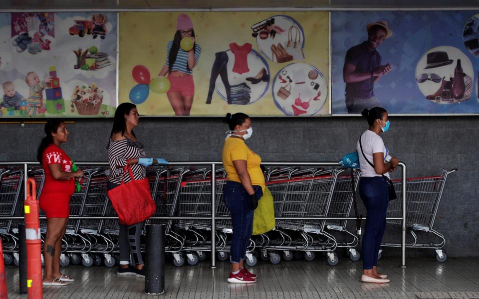 Women queuing at a supermarket - Bienvendio Velasco/Shutterstcok