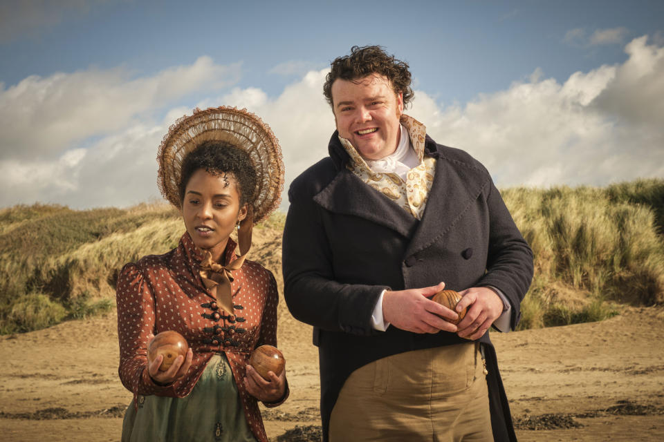 Georgiana (Crystal Clarke) and Arthur (Turlough Convery) are playing a game of bowls on the beach