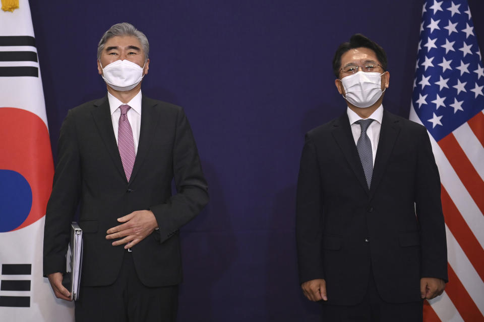 U.S. special representative for North Korea Sung Kim, left, and South Korea's Special Representative for Korean Peninsula Peace and Security Affairs Noh Kyu-duk pose for a photo during their bilateral meeting at a hotel in Seoul Monday, June 21, 2021. (Jung Yeon-je/Pool Photo via AP)