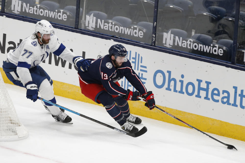 Tampa Bay Lightning's Victor Hedman, left, of Sweden, chases Columbus Blue Jackets' Liam Foudy behind the net during the second period of an NHL hockey game Saturday, Jan. 23, 2021, in Columbus, Ohio. (AP Photo/Jay LaPrete)