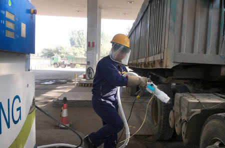 A worker prepares to fuel liquefied natural gas (LNG) for a LNG truck at a gas station in Yutian county, China's Hebei province September 29, 2017. REUTERS/Jason Lee