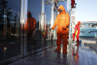 Hygienic and anti-epidemic officials disinfect the public walkway outside the Songdowon General Foodstuff Factory in the city of Wonsan, Kangwon Province, North Korea DPRK, on Wednesday, Oct., 28, 2020. (AP Photo/Jon Chol Jin)