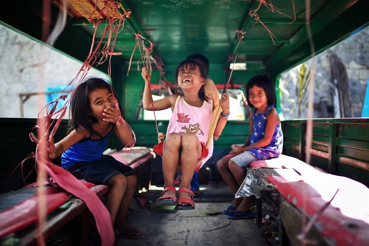 <div class="caption-credit"> Photo by: Mac Kwan</div>Chinese photographer Mac Kwan took this photo near an market in Indonesia. "I just took my camera and walked away from the crowd," he writes. "I was in a slum which is not far away. Kids here were so curious about this foreigner and his camera. They just wanted to be the centre of it."