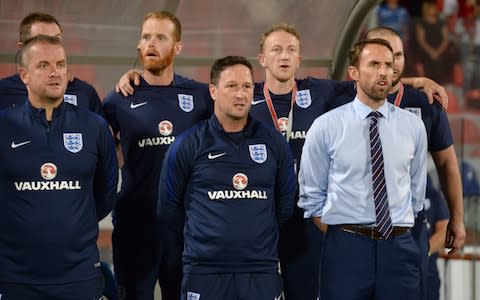 England's team manager Gareth Southgate (R) sings the national anthem prior to the Malta game - Credit: AFP