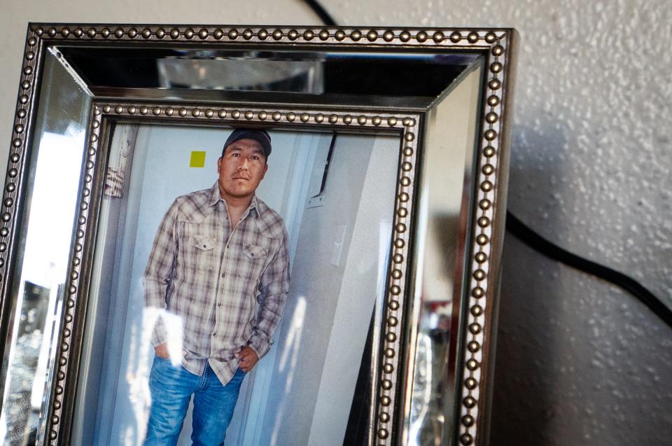 A photo of Emmanuel Pop Ba is displayed in a memorial at his family's home in North Austin.