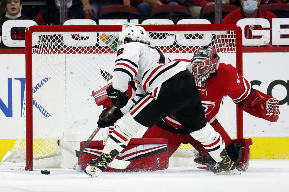 Carolina Hurricanes goaltender Petr Mrazek (34) blocks the shot of Chicago Blackhawks' Alex DeBrincat (12) during the second period of an NHL hockey game in Raleigh, N.C., Thursday, May 6, 2021. (AP Photo/Karl B DeBlaker)