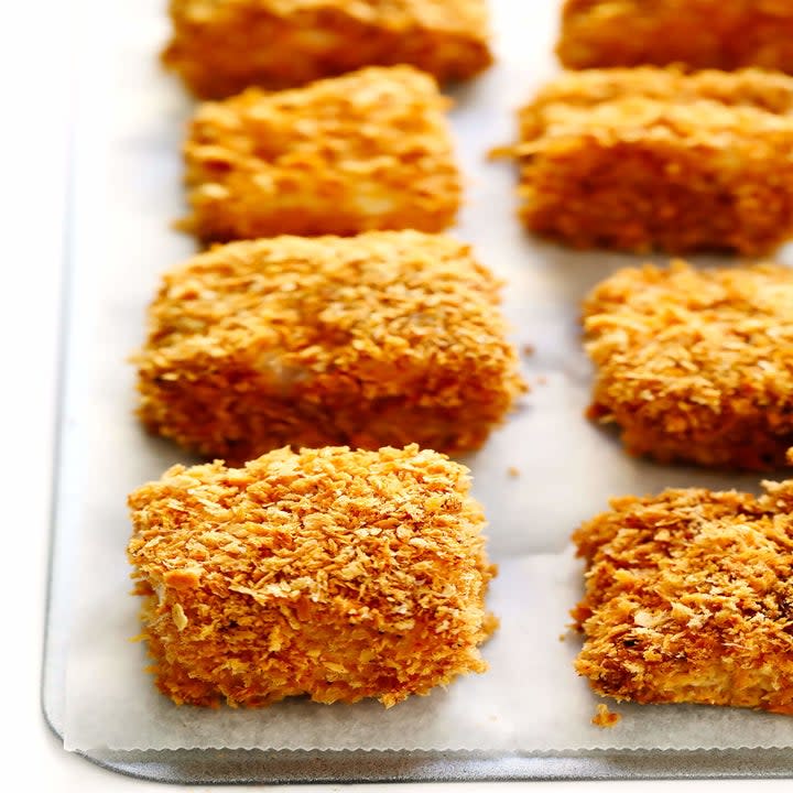 A handful of crispy fish pieces on a baking sheet.