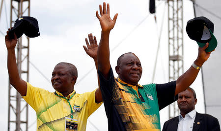 FILE PHOTO: President of the ANC Cyril Ramaphosa and his deputy David Mabuza (L) wave to supporters ahead of the ANC's 106th anniversary celebrations in East London, South Africa, January 13, 2018. REUTERS/Siphiwe Sibeko/File Photo