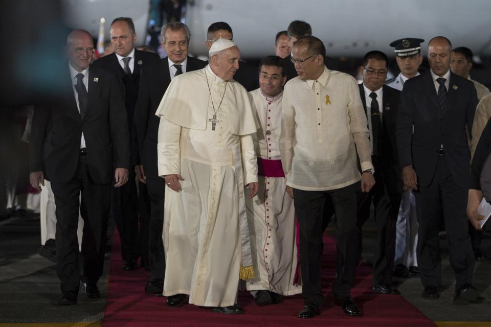 Pope Francis is greeted by Philippines' President Benigno Aquino upon his arrival at Villamor Air Base for a state and pastoral visit, in Manila