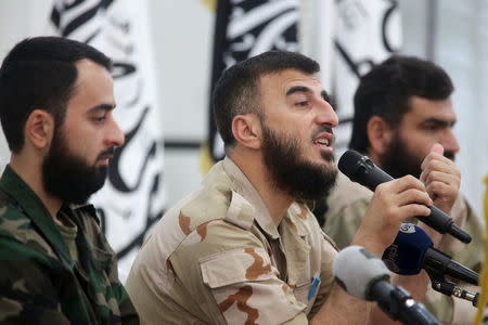 Zahran Alloush (C), commander of Jaysh al Islam, talks during a conference in the town of Douma, eastern Ghouta in Damascus, Syria August 27, 2014. REUTERS/Bassam Khabieh