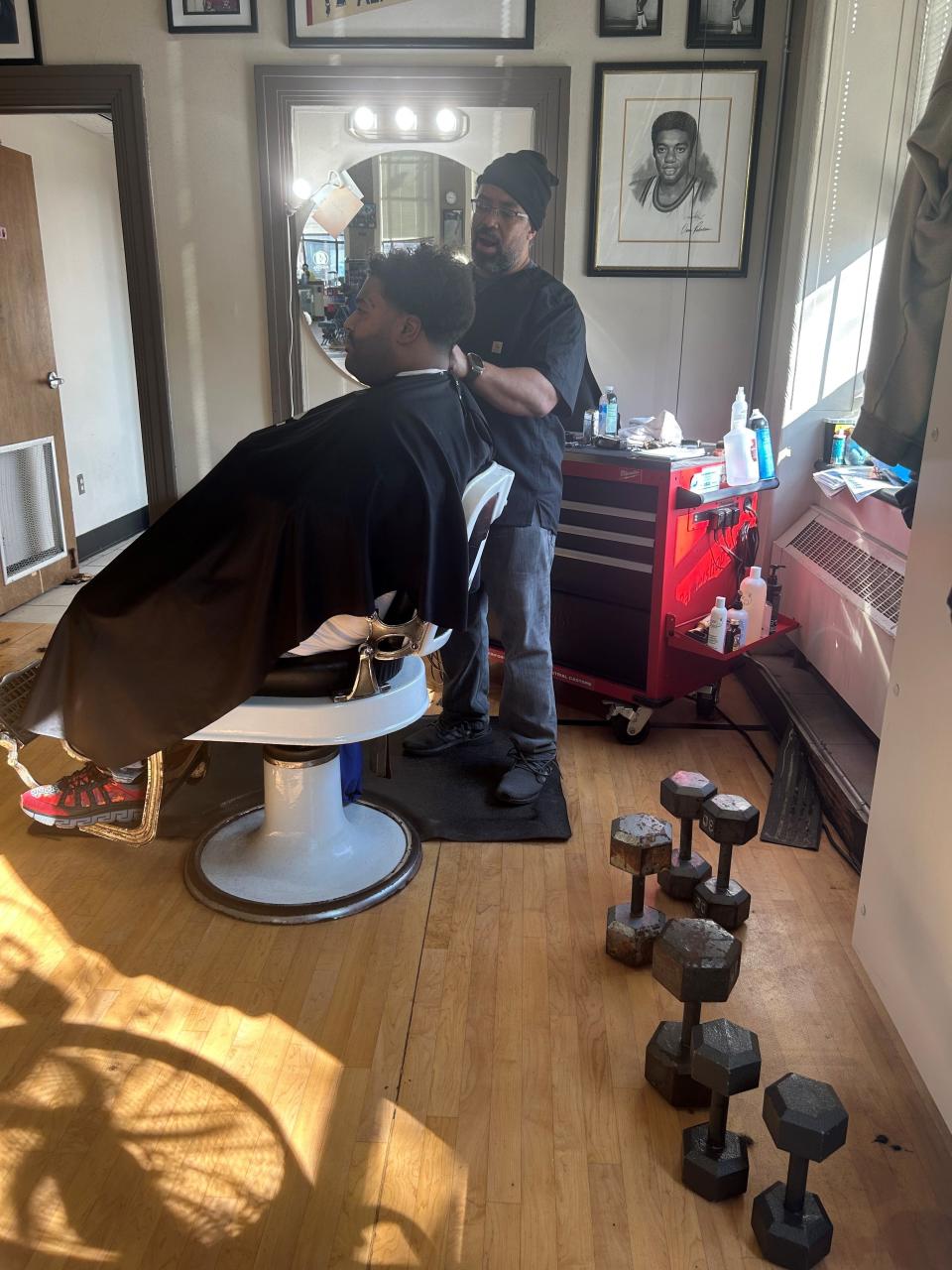 Richard Armstead cuts Loujefe Bolden's hair at Gee's Clippers, 2200 N. Dr. Martin Luther King Jr. Drive on March 1, 2023. Former NBA basektball star Jalen Rose said the minimum a man should pay for a haircut is $100, which created a lot of conversation at area barbershop. Bolden, 38, has been a client of Armstead for 12 years. Bolden pays $55 for a haircut and razor line. He said he would pay $100 for a haircut if he could afford it because of the feeling you get after you get a fresh haircut. Armstead keeps dumbells by his work station to squeeze in a workout in between clients.