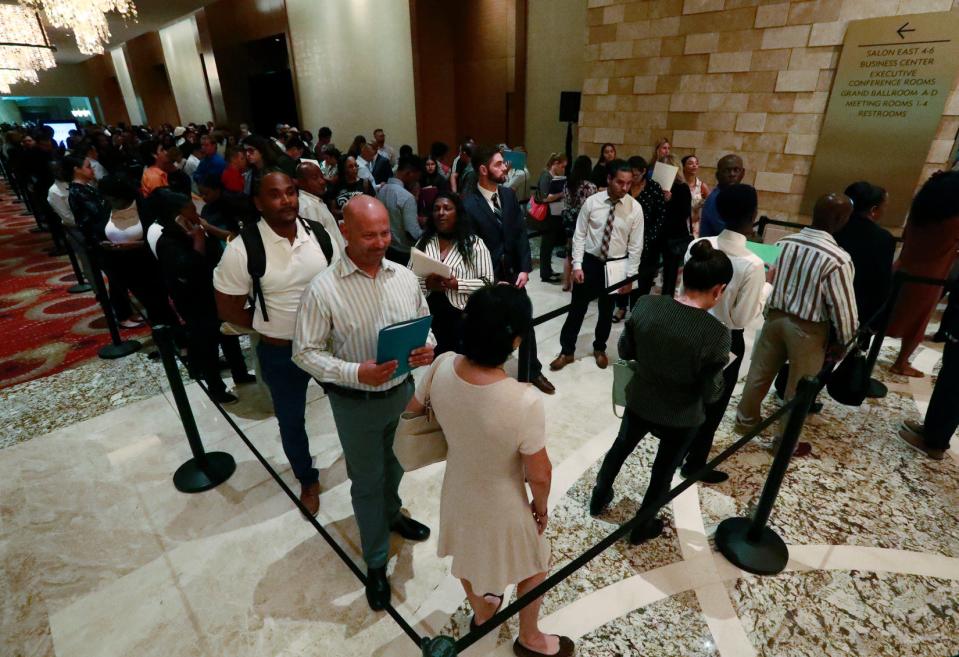 Job applicants line up at the Seminole Hard Rock Hotel & Casino Hollywood during a job fair in Hollywood, Florida.