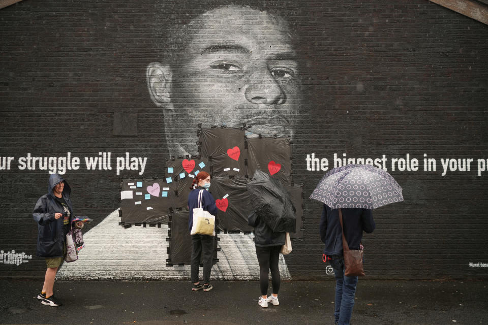 <p>MANCHESTER, ENGLAND - JULY 12: Local residents put messages of support on the plastic that covers offensive graffiti on the vandalised mural of Manchester United striker and England player Marcus Rashford on the wall of a cafe on Copson Street, Withington on July 12, 2021 in Manchester, England. Rashford and other Black players on England's national football team have been the target of racist abuse, largely on social media, after the team's loss to Italy in the UEFA European Football Championship last night. England manager Gareth Southgate, Prime Minister Boris Johnson, and the Football Association have issued statements condemning the abuse. (Photo by Christopher Furlong/Getty Images)</p>
