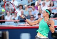 Aug 10, 2018; Montreal, Quebec, Canada; Caroline Garcia of France hits a shot against Simona Halep of Romania (not pictured) during the Rogers Cup tennis tournament at Stade IGA. Mandatory Credit: Jean-Yves Ahern-USA TODAY Sports