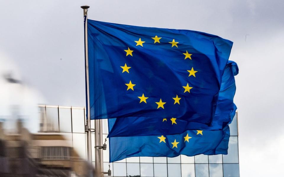 Three European Union (EU) flags fly outside the Berlaymont building, headquarters of the European Commission - Bloomberg