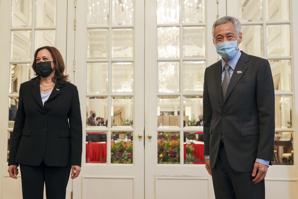 U.S. Vice President Kamala Harris, left, stands next to Singapore's Prime Minister Lee Hsien Loong before their bilateral meeting at the Istana in Singapore Monday, Aug. 23, 2021. (Evelyn Hockstein/Pool Photo via AP)