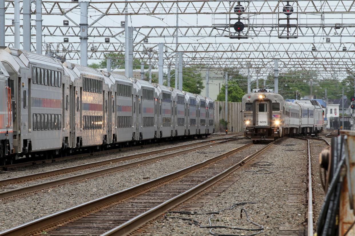 A NJ Transit train (right) rolls south out of the Long Branch station Tuesday, June 1, 2021. 