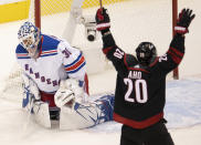 New York Rangers goaltender Henrik Lundqvist (30) reacts as Carolina Hurricanes center Sebastian Aho (20) celebrates his team's goal during the first period of an NHL Stanley Cup playoff hockey game in Toronto, Monday, Aug. 3, 2020. (Frank Gunn/The Canadian Press via AP)