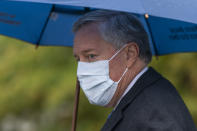 White House chief of staff Mark Meadows glances as he responds to reporters questions outside the West Wing on the North Lawn of the White House, Sunday, Oct. 25, 2020, in Washington. (AP Photo/Manuel Balce Ceneta)