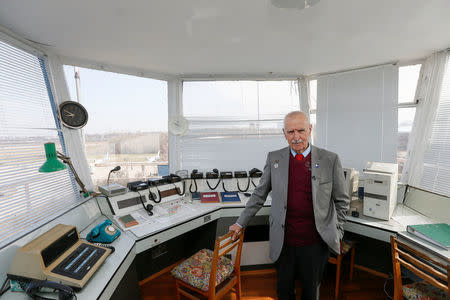 Ukrainian military pilot Mykola Volkozub, who was deployed in a team to fly a helicopter over the reactor to measure the temperature and composition of gases after the accident at the Chernobyl nuclear power plant in 1986, poses for a picture inside a flights control room at the Antonov aircraft plant in Kiev, Ukraine April 6, 2018. Picture taken April 6, 2018. REUTERS/Valentyn Ogirenko