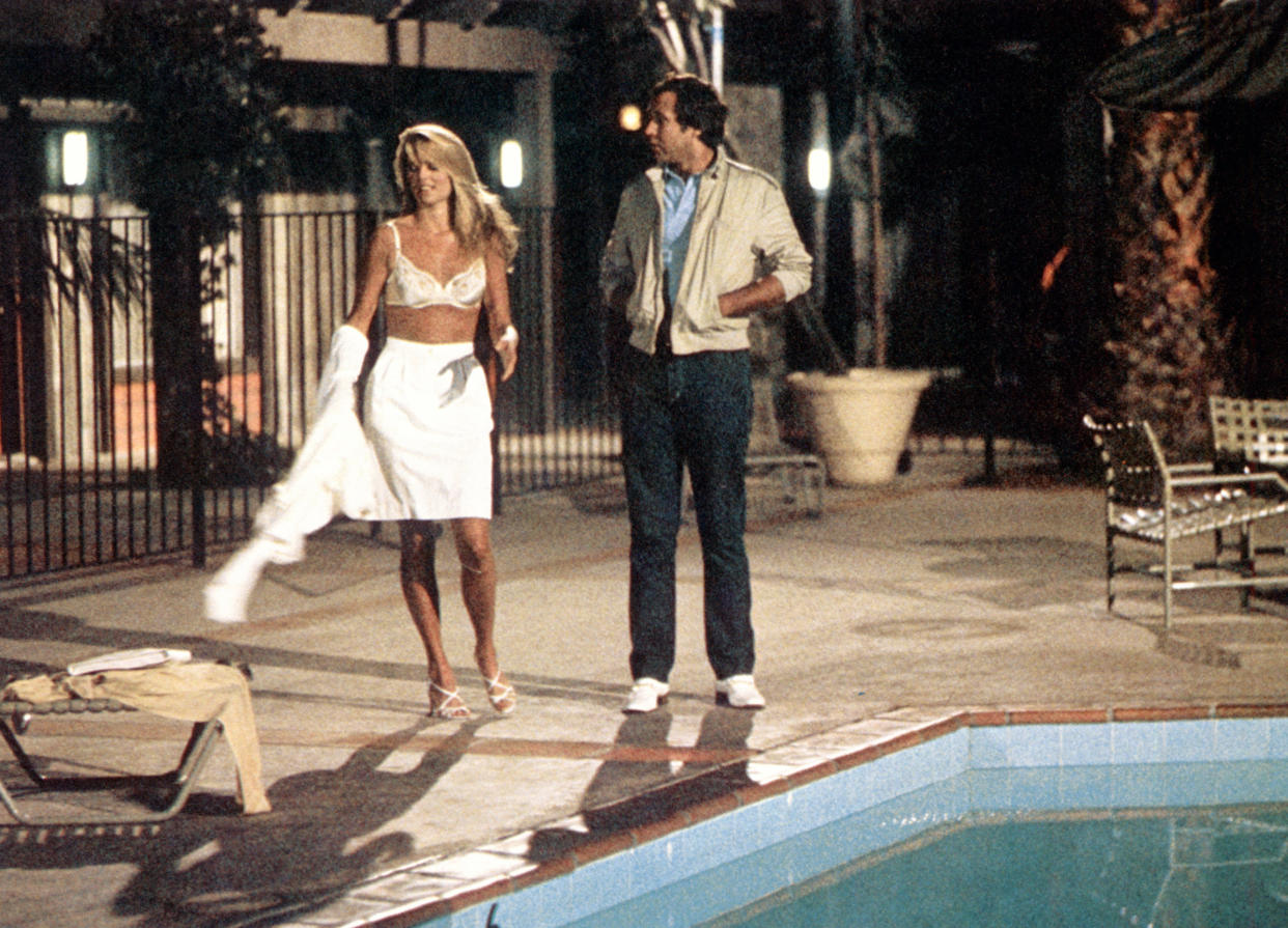 Christie Brinkley and Chase in the famous pool scene from National Lampoon's Vacation. (Photo: Warner Bros./Courtesy Everett Collection)