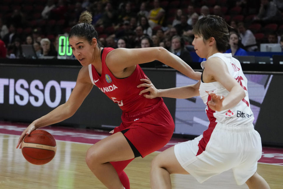 Canada's Kia Nurse runs past Japanese defenders during their game at the women's Basketball World Cup in Sydney, Australia, Sunday, Sept. 25, 2022. (AP Photo/Mark Baker)