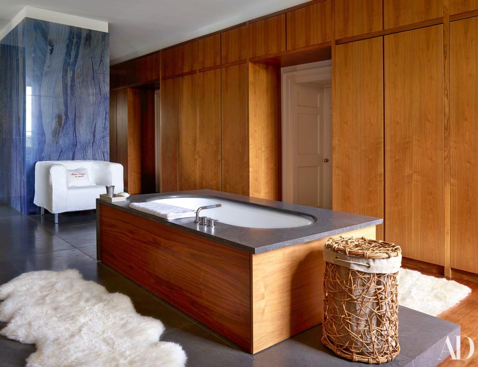 Blue Brazilian marble and sheepskin rugs glamorize the master bath.