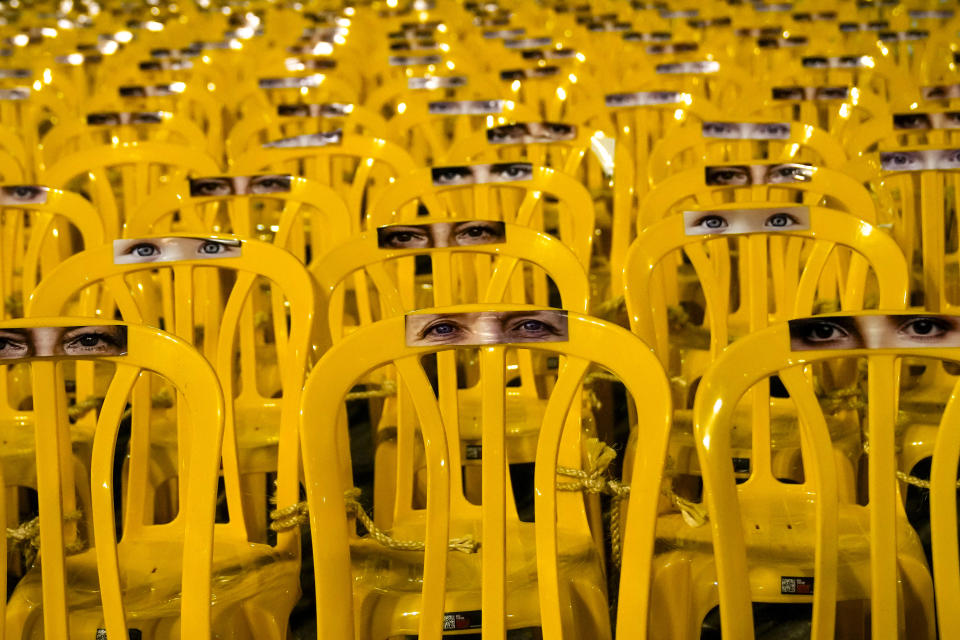 Images of human eyes are placed on empty chairs tied together in an art installation depicting hostages held by Hamas in the Hostages Square at the Museum of Art in Tel Aviv, Israel, Wednesday, Nov. 29, 2023. International mediators on Wednesday worked to extend the truce in Gaza, encouraging Hamas militants to keep freeing hostages in exchange for the release of Palestinian prisoners and further relief from Israel's air and ground offensive.(AP Photo/Maya Alleruzzo)