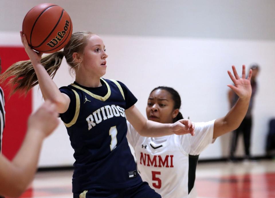 Ruidoso's Bayler Pritchett (left) attempts to pass against New Mexico Military's Jaylah Clay during a Feb. 16, 2024 basketball game in Roswell.