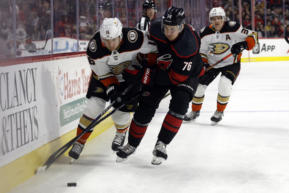 Anaheim Ducks' Ryan Strome (16) battles Carolina Hurricanes' Brady Skjei (76) for the puck during the first period of an NHL hockey game in Raleigh, N.C., Saturday, Feb. 25, 2023. (AP Photo/Karl B DeBlaker)