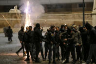 Flares explode as people gather in Piazza del Popolo square during a protest called by Forza Nuova far right group against the government restriction measures to curb the spread of COVID-19, in Rome Saturday, Oct. 24, 2020. A midnight-to-5 a.m. curfew in Italy's Lazio region, which includes Rome, begins on Friday and lasts for 30 days, under orders from regional governor Nicola Zingaretti. (Cecilia Fabiano/LaPresse via AP)