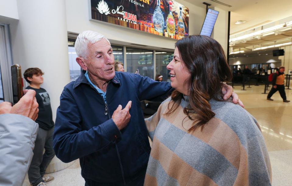 Nancy Galloway, 53, right, chatted with her dad Alan Freedman, 82, as he arrived at the Louisville Muhammad Ali International Airport in Louisville, Ky. on Nov. 15, 2022.  Galloway used DNA testing to identify Freedman as her father and located him in Australia.