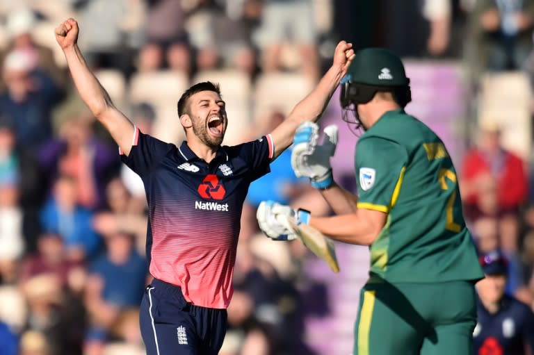 England's Mark Wood (L) celebrates winning against South Africa at the second One-Day International in Southampton on May 27, 2017