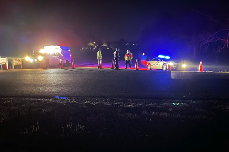 Authorities stand near where two Blackhawk helicopters crashed during a training incident in Trigg County, Kentucky. (WSMV)