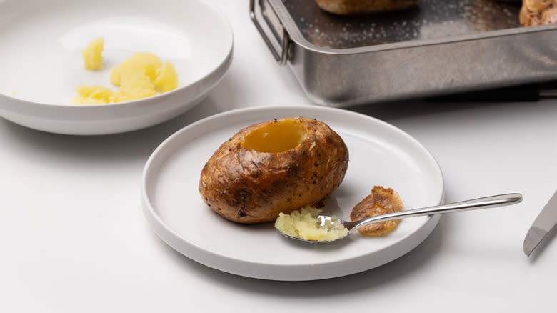 hollowed out baked potato on white plate