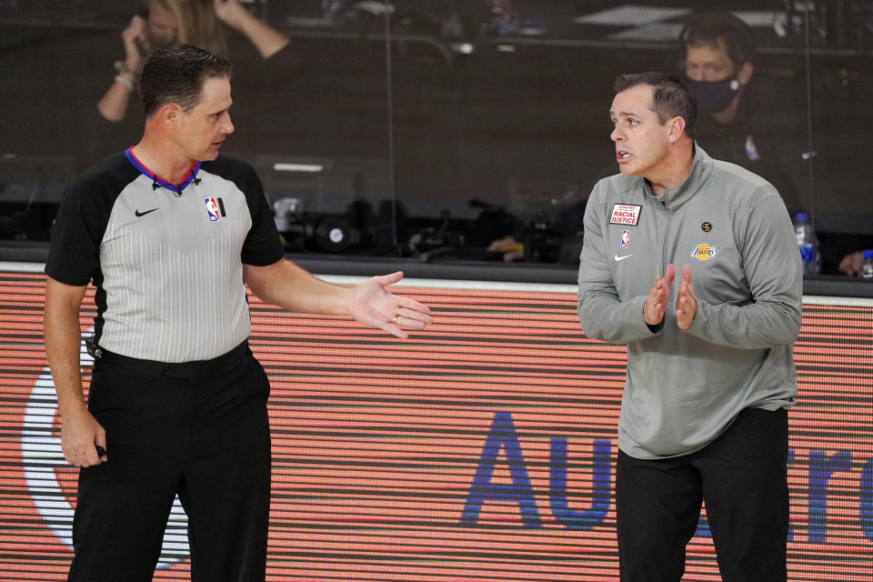 Los Angeles Lakers head coach Frank Vogel, right, talks with an official during the first half of an NBA conference final playoff basketball game against the Denver Nuggets Thursday, Sept. 24, 2020, in Lake Buena Vista, Fla. (AP Photo/Mark J. Terrill)