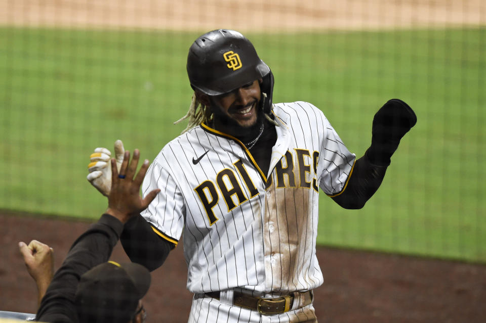 San Diego Padres shortstop Fernando Tatis Jr. (23) celebrates after scoring during the third inning of a baseball game against the Seattle Mariners Saturday, Sept. 19, 2020, in San Diego. (AP Photo/Denis Poroy)