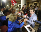 Georgia head coach Kirby Smart signs autographs as her arrives for the Southeastern Conference NCAA college football Media Days in Hoover, Ala., Tuesday, July 16, 2019. (Curtis Compton/Atlanta Journal-Constitution via AP)