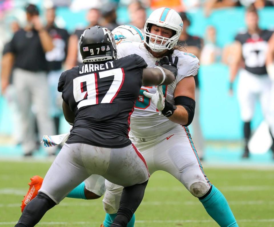 Miami Dolphins center Austin Reiter (61) blocks Atlanta Atlanta Falcons defensive tackle Grady Jarrett (97) during fourth quarter of an NFL football game at Hard Rock Stadium on Sunday, October 24, 2021 in Miami Gardens, Florida.