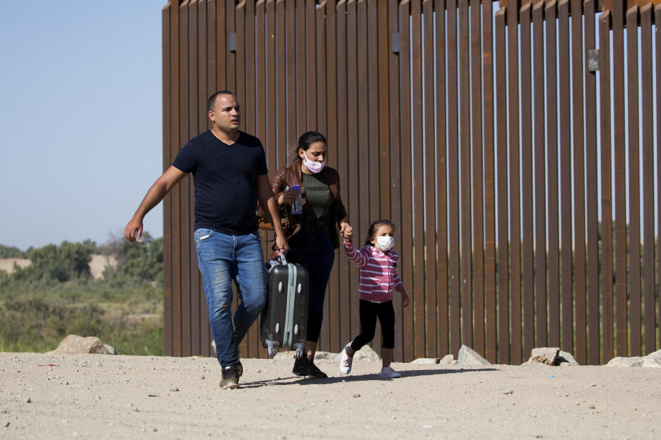 Migrants from Cuba on the U.S.-Mexico border turn themselves in to authorities on May 13, 2021, in Yuma, Arizona. / Credit: RINGO CHIU/AFP via Getty Images